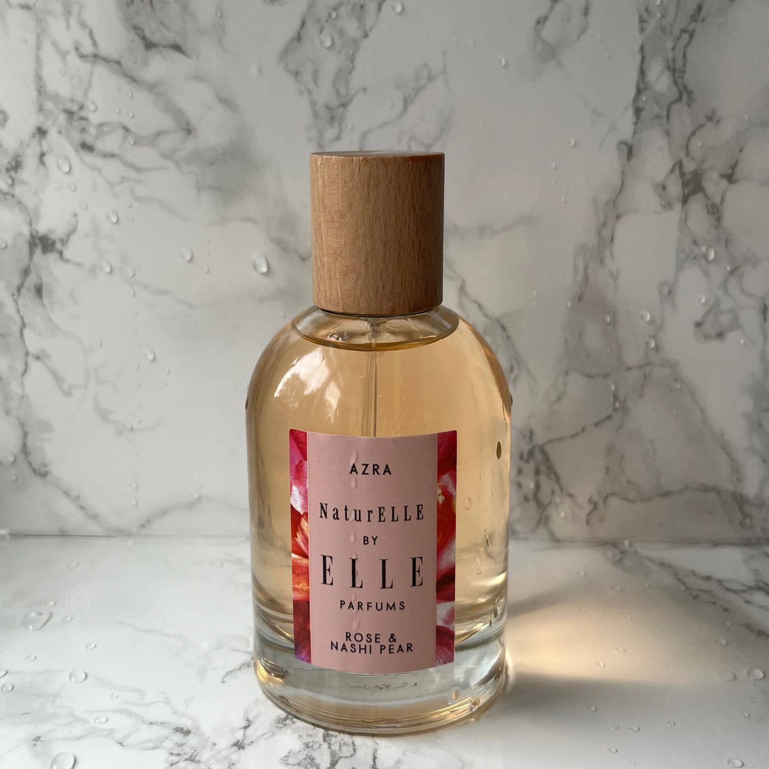 Lifestyle image of NaturELLE Azra by ELLE Parfums 100ml. The main ingredients in Azra Eau De Parfum are Rose & Nashi Pear. It's vegan, cruelty-free, naturally and ethically sourced. It's perfect for day and night.