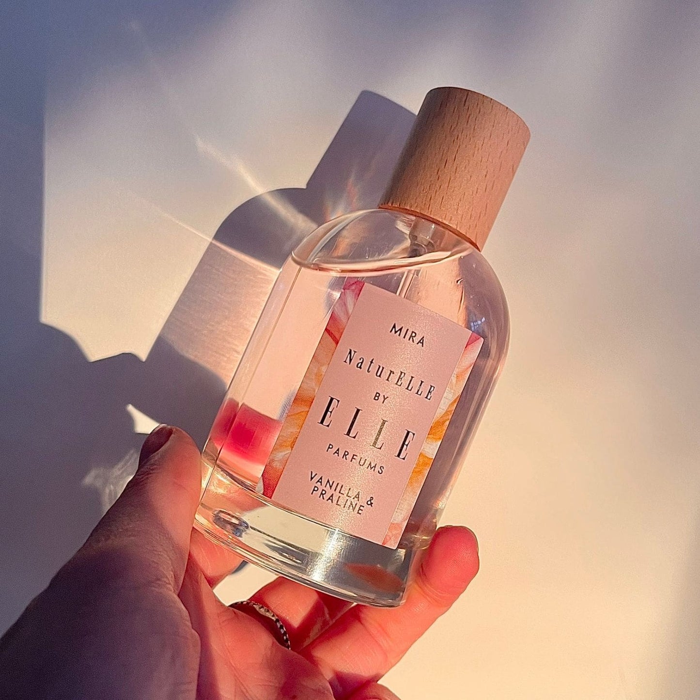 Lifestyle image of Mira by ELLE Parfums 100ml. The main ingredients in Mira Eau De Parfum are Vanilla & Praline. It's vegan, cruelty-free, naturally and ethically sourced. It's perfect for day and night.