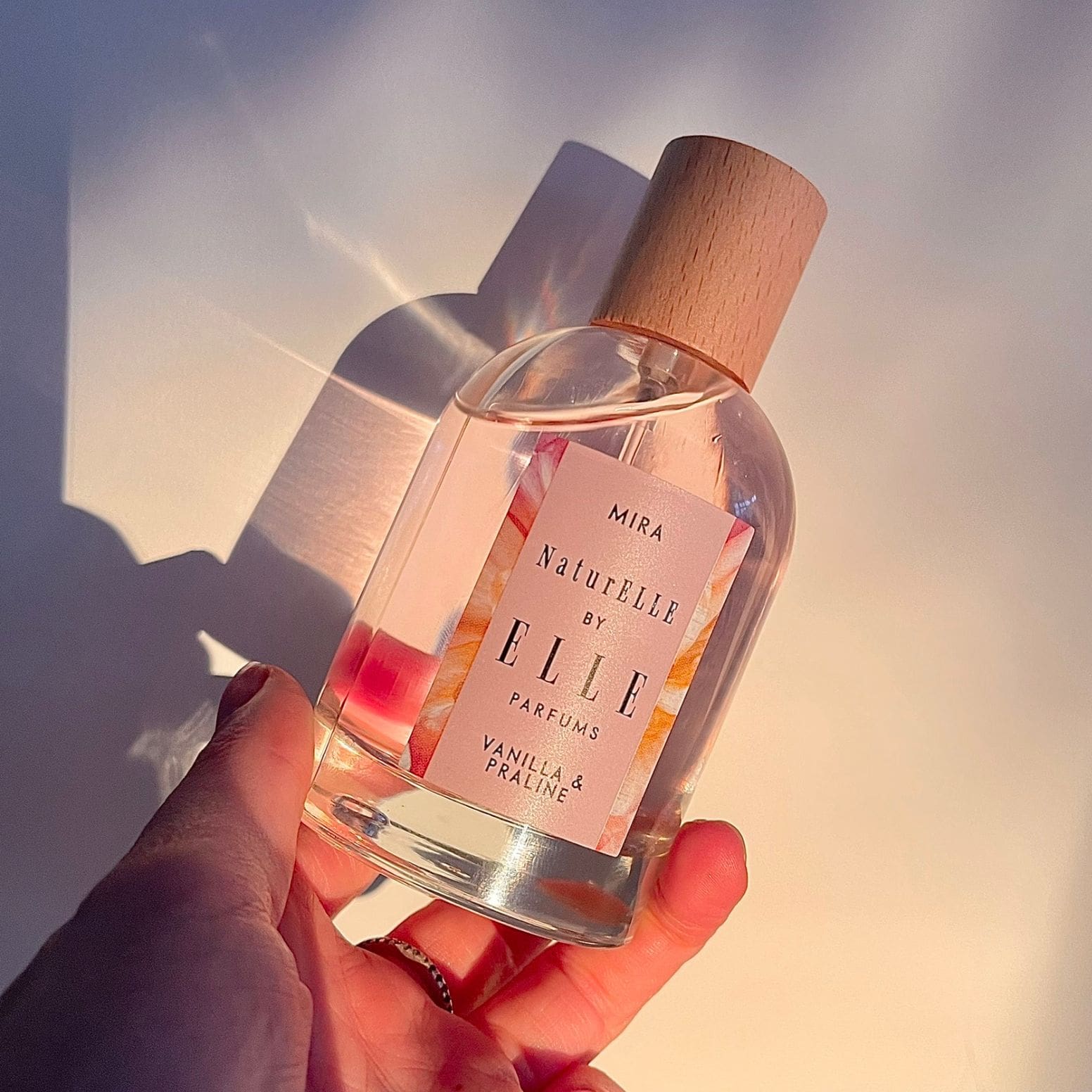 Lifestyle image of Mira by ELLE Parfums 100ml. The main ingredients in Mira Eau De Parfum are Vanilla & Praline. It's vegan, cruelty-free, naturally and ethically sourced. It's perfect for day and night.